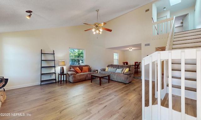 5325 Julington Ridge Dr S, Jacksonville, FL 32258 - living room with stairs, light wood-style flooring, a ceiling fan, and high vaulted ceiling