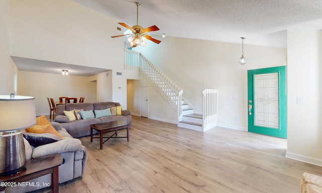 5325 Julington Ridge Dr S, Jacksonville, FL 32258 - living area with a ceiling fan, stairway, light wood-style floors, high vaulted ceiling, and baseboards