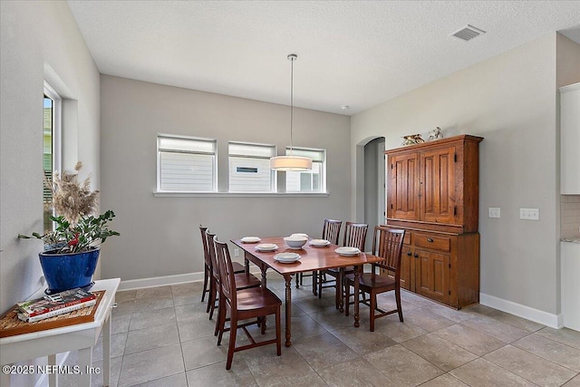 529 Crosswater Lake Dr, Ponte Vedra, FL 32081 - dining space featuring arched walkways, baseboards, and light tile patterned flooring