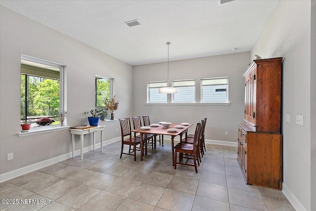 529 Crosswater Lake Dr, Ponte Vedra, FL 32081 - dining space with a textured ceiling, baseboards, and light tile patterned floors