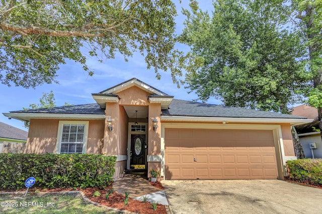 1695 Northglen Cir, Middleburg, FL 32068 - view of front of house with an attached garage, stucco siding, and concrete driveway