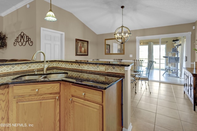 1695 Northglen Cir, Middleburg, FL 32068 - kitchen featuring a sink, dark stone countertops, a chandelier, lofted ceiling, and decorative light fixtures