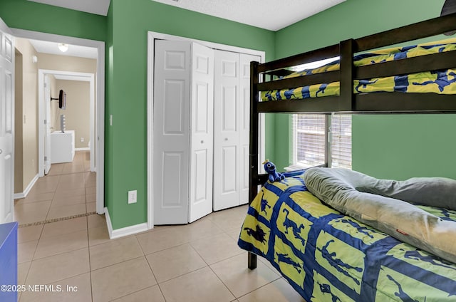 1695 Northglen Cir, Middleburg, FL 32068 - bedroom featuring light tile patterned flooring, baseboards, and a closet