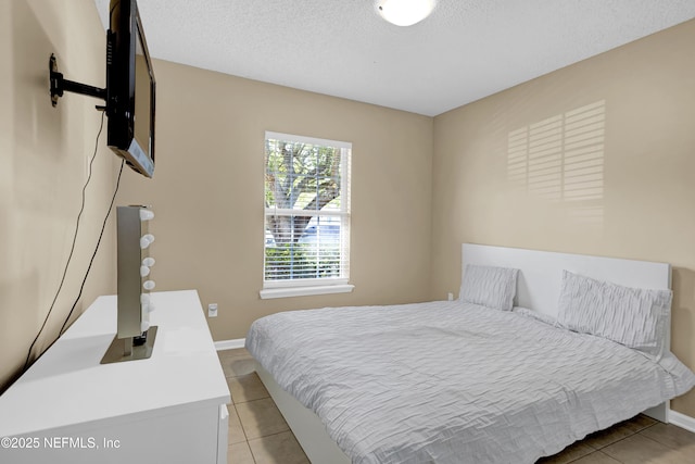 1695 Northglen Cir, Middleburg, FL 32068 - bedroom featuring light tile patterned flooring, baseboards, and a textured ceiling