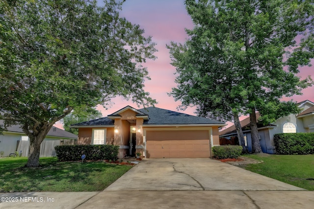 1695 Northglen Cir, Middleburg, FL 32068 - single story home with stucco siding, an attached garage, concrete driveway, and a front lawn