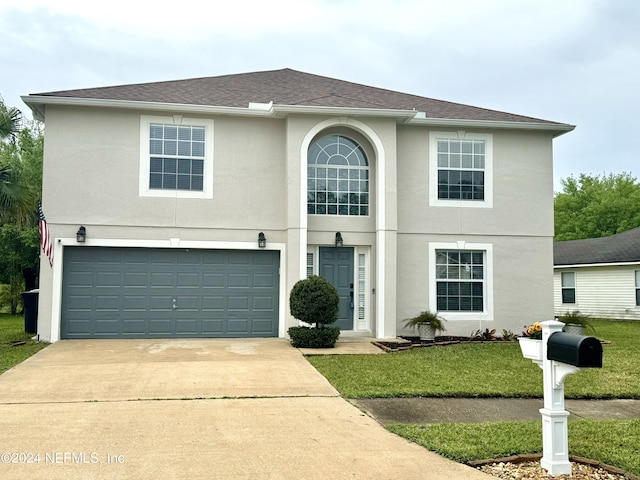 1483 Seawolf Trl N, Jacksonville, FL 32221 - traditional-style house featuring a garage, driveway, a front yard, stucco siding, and a shingled roof