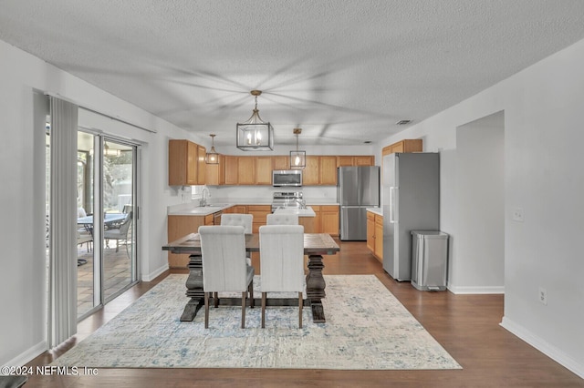 1483 Seawolf Trl N, Jacksonville, FL 32221 - dining room featuring a textured ceiling, dark wood-style flooring, baseboards, and a chandelier