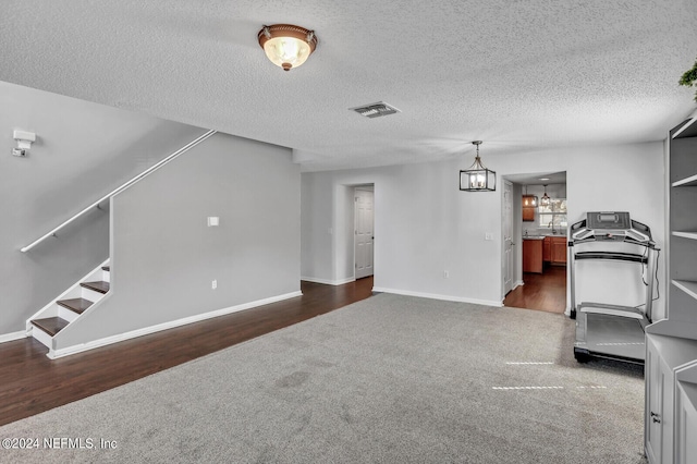 1483 Seawolf Trl N, Jacksonville, FL 32221 - living room with dark colored carpet, a chandelier, baseboards, a textured ceiling, and stairway