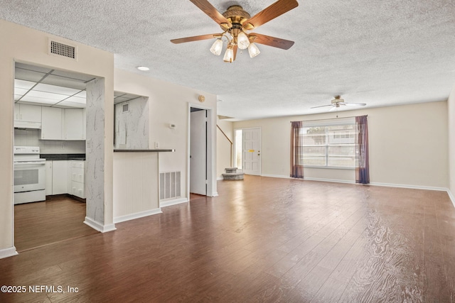 695 A1A N Unit 123, Ponte Vedra Beach, FL 32082 - unfurnished living room with ceiling fan, a textured ceiling, dark wood-type flooring, and baseboards