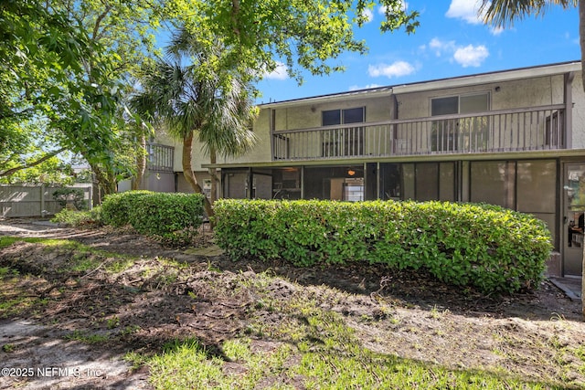 695 A1A N Unit 123, Ponte Vedra Beach, FL 32082 - back of house featuring stucco siding and a balcony