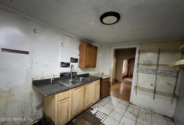 1419 W 24th St, Jacksonville, FL 32209 - kitchen with a sink, dark countertops, light tile patterned floors, and ornamental molding
