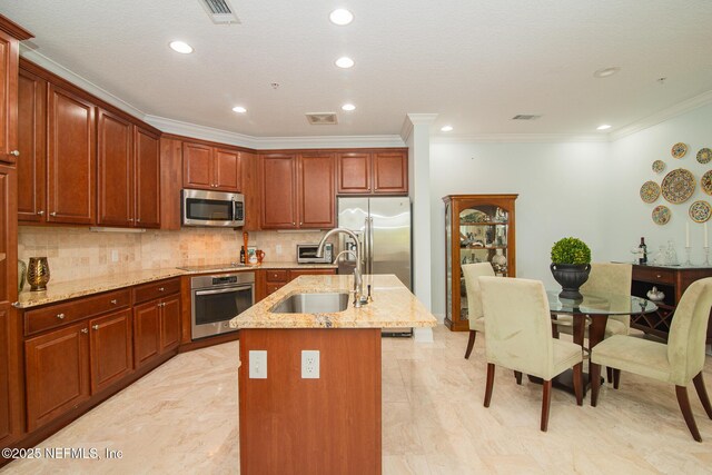 4300 S Beach Pkwy Unit 4306, Jacksonville Beach, FL 32250 - kitchen with appliances with stainless steel finishes, a sink, crown molding, an island with sink, and light stone countertops