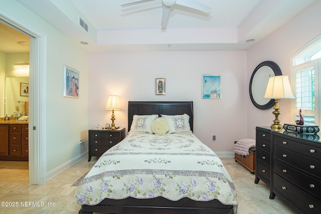 4300 S Beach Pkwy Unit 4306, Jacksonville Beach, FL 32250 - bedroom with a tray ceiling, baseboards, ensuite bathroom, and ceiling fan