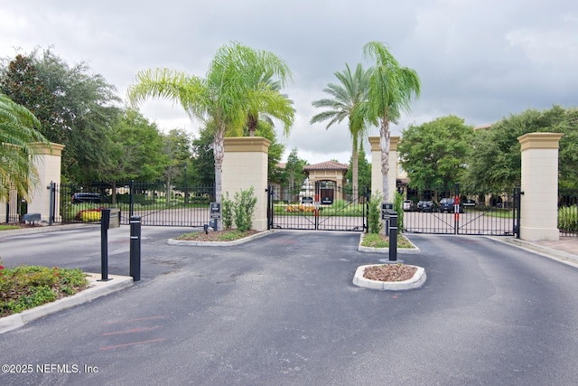 4300 S Beach Pkwy Unit 4306, Jacksonville Beach, FL 32250 - view of asphalt street featuring a gate, a gated entry, and curbs