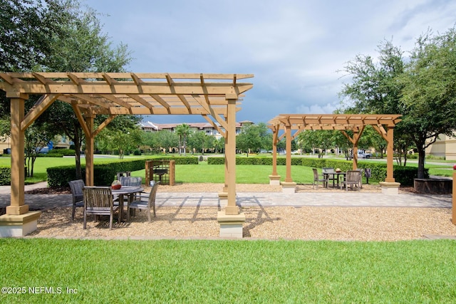 4300 S Beach Pkwy Unit 4306, Jacksonville Beach, FL 32250 - view of property's community featuring a pergola, a yard, outdoor dining area, and a patio