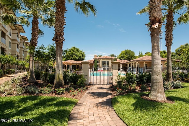 4300 S Beach Pkwy Unit 4306, Jacksonville Beach, FL 32250 - view of front facade with a tiled roof, a community pool, and stucco siding