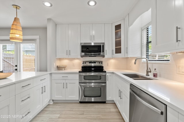 338 Magnolia St, Atlantic Beach, FL 32233 - kitchen featuring appliances with stainless steel finishes, a sink, healthy amount of natural light, recessed lighting, and white cabinets