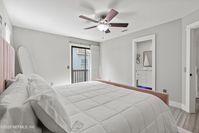 338 Magnolia St, Atlantic Beach, FL 32233 - bedroom featuring wood finished floors, baseboards, ceiling fan, and connected bathroom