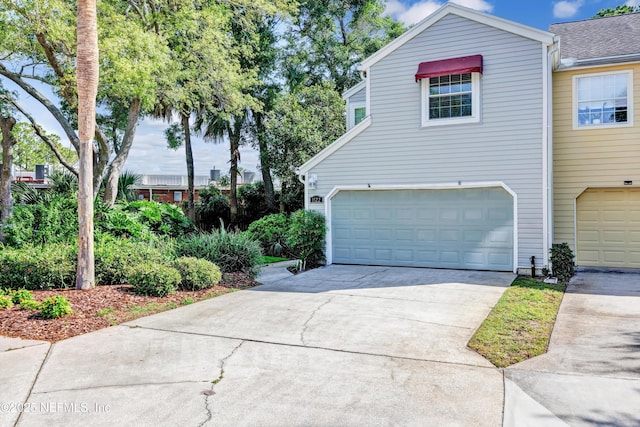 1522 Sand Dollar Cir, Neptune Beach, FL 32266 - view of front of property with a garage and concrete driveway