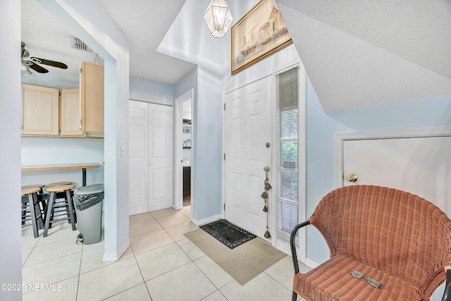 1522 Sand Dollar Cir, Neptune Beach, FL 32266 - entrance foyer with baseboards, light tile patterned flooring, and a ceiling fan
