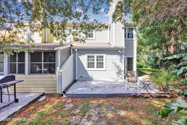 1522 Sand Dollar Cir, Neptune Beach, FL 32266 - rear view of property featuring a deck, a shingled roof, a chimney, and a sunroom