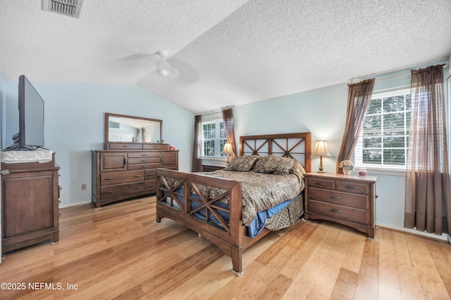 1522 Sand Dollar Cir, Neptune Beach, FL 32266 - bedroom featuring light wood-style floors, a textured ceiling, lofted ceiling, and a ceiling fan