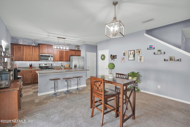 137 Codman Dr, Saint Augustine, FL 32084 - dining area with light colored carpet, a chandelier, and baseboards