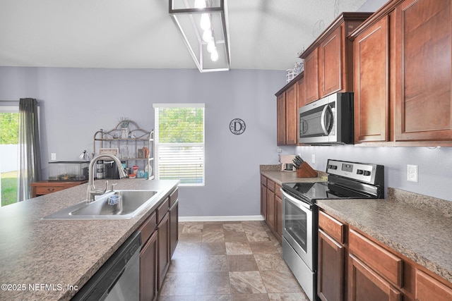 137 Codman Dr, Saint Augustine, FL 32084 - kitchen featuring stainless steel appliances, a sink, healthy amount of natural light, and baseboards