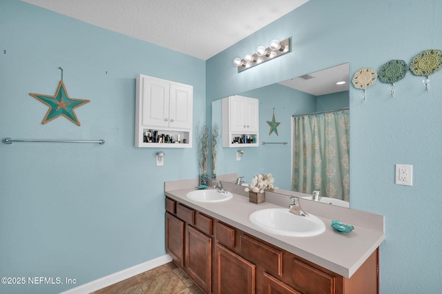 137 Codman Dr, Saint Augustine, FL 32084 - bathroom featuring double vanity, baseboards, a textured ceiling, and curtained shower