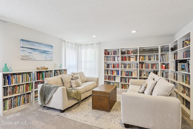 864 Collinswood Dr W, Jacksonville, FL 32225 - living area featuring bookshelves, a textured ceiling, carpet, and recessed lighting