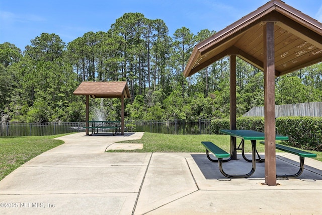 864 Collinswood Dr W, Jacksonville, FL 32225 - surrounding community with a patio area and view of wooded area