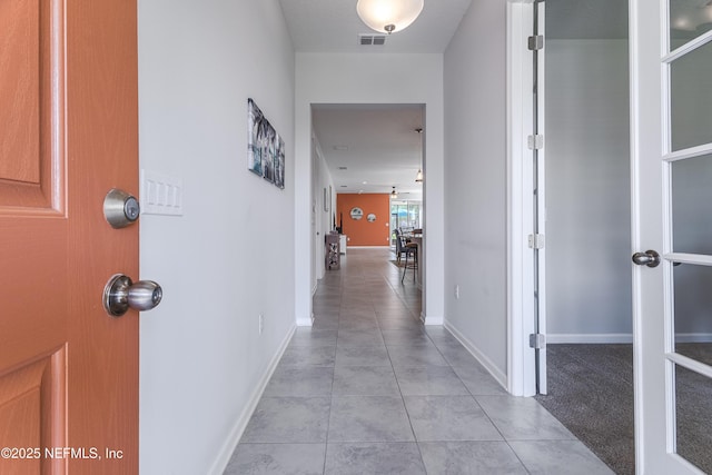 497 Convex Ln, Saint Augustine, FL 32095 - corridor featuring light tile patterned floors and baseboards