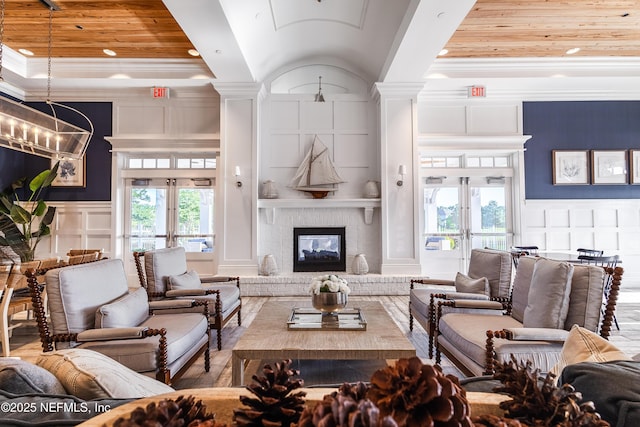 497 Convex Ln, Saint Augustine, FL 32095 - living room with a decorative wall, french doors, a fireplace, crown molding, and decorative columns