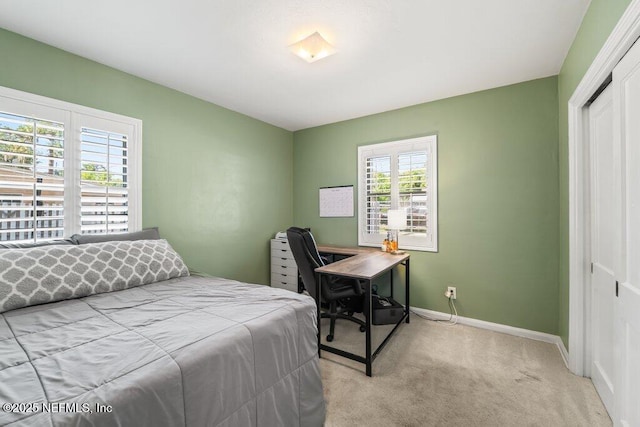 6500 Altama Rd, Jacksonville, FL 32216 - bedroom with light carpet, a closet, baseboards, and a desk