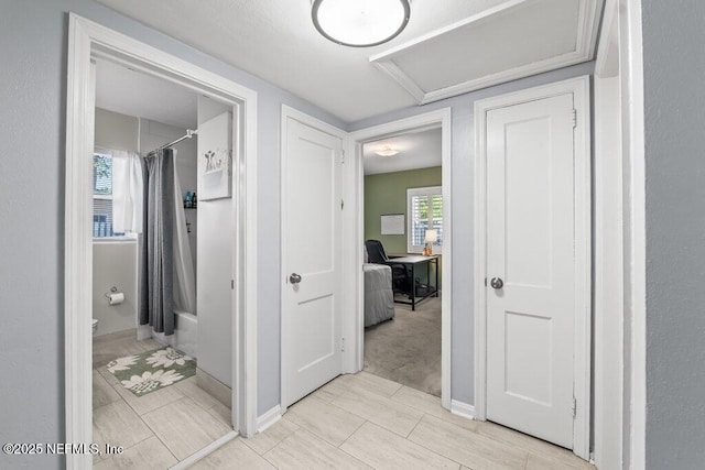 6500 Altama Rd, Jacksonville, FL 32216 - hallway with healthy amount of natural light, a desk, and baseboards