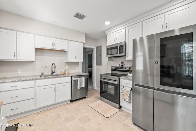 6500 Altama Rd, Jacksonville, FL 32216 - kitchen with appliances with stainless steel finishes, a sink, white cabinetry, and recessed lighting