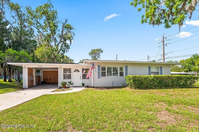 6500 Altama Rd, Jacksonville, FL 32216 - ranch-style house with driveway, a front yard, and an attached carport