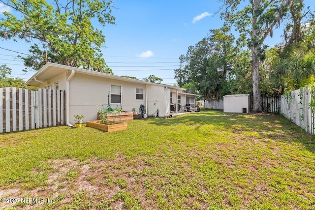 6500 Altama Rd, Jacksonville, FL 32216 - view of yard featuring a garden, a storage unit, and an outdoor structure