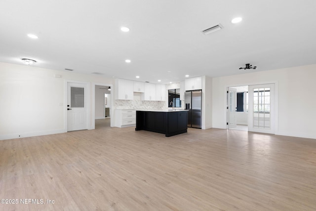13 Clarendon Ct S, Palm Coast, FL 32137 - unfurnished living room featuring light wood-style floors, baseboards, and recessed lighting