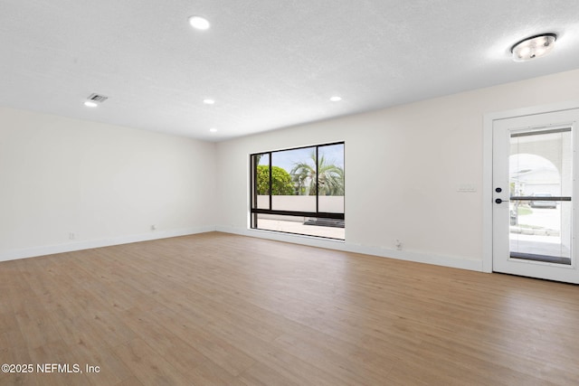 13 Clarendon Ct S, Palm Coast, FL 32137 - spare room with light wood finished floors, recessed lighting, baseboards, and a textured ceiling