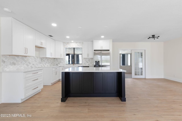 13 Clarendon Ct S, Palm Coast, FL 32137 - kitchen with stainless steel fridge with ice dispenser, a kitchen island, backsplash, white cabinetry, and recessed lighting