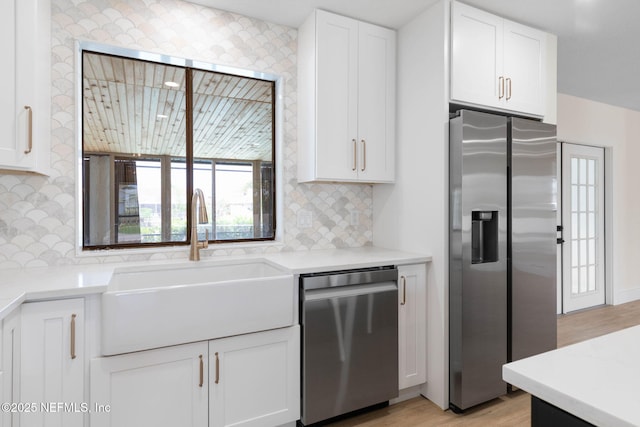 13 Clarendon Ct S, Palm Coast, FL 32137 - kitchen featuring stainless steel appliances, a sink, white cabinets, and backsplash