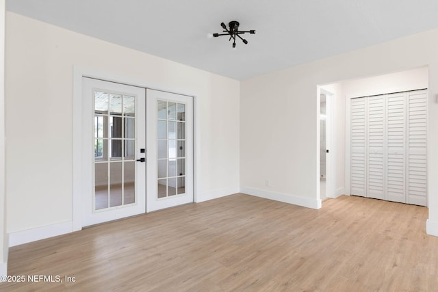 13 Clarendon Ct S, Palm Coast, FL 32137 - unfurnished room featuring light wood-style floors, french doors, and baseboards