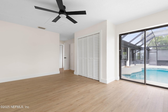 13 Clarendon Ct S, Palm Coast, FL 32137 - empty room featuring wood finished floors, a ceiling fan, baseboards, and a sunroom