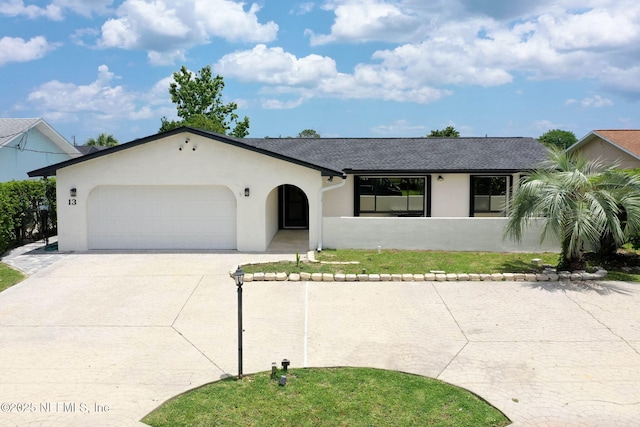 13 Clarendon Ct S, Palm Coast, FL 32137 - view of front of home featuring concrete driveway, stucco siding, an attached garage, and a shingled roof