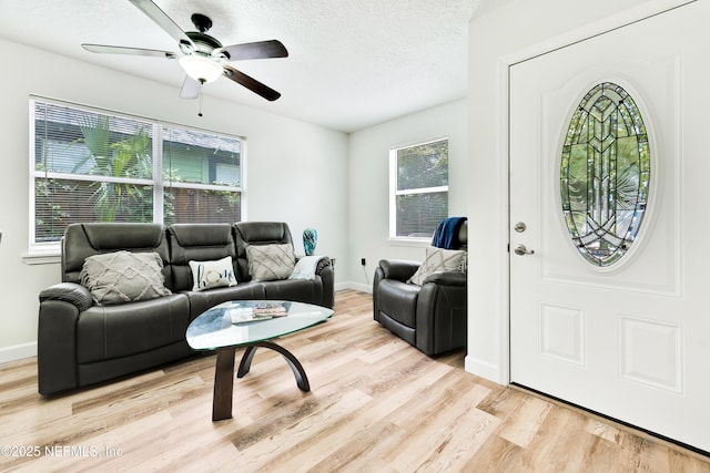 159 Twine St, Saint Augustine, FL 32084 - living area with wood finished floors, a ceiling fan, a textured ceiling, and baseboards
