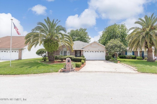 1275 Pirates Cove Ln, Fleming Island, FL 32003 - view of front of home featuring concrete driveway, an attached garage, and a front yard