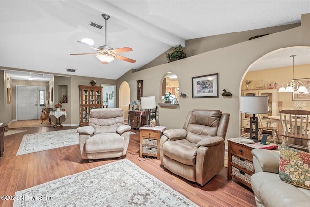 1275 Pirates Cove Ln, Fleming Island, FL 32003 - living room featuring arched walkways, wood finished floors, ceiling fan, a chandelier, and baseboards