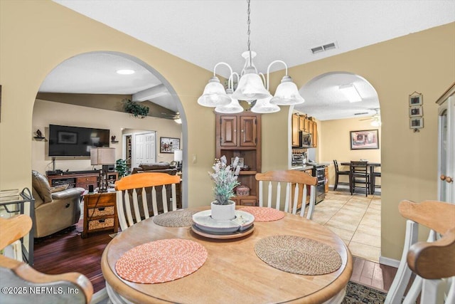 1275 Pirates Cove Ln, Fleming Island, FL 32003 - dining area with arched walkways, a chandelier, ceiling fan, and light tile patterned floors