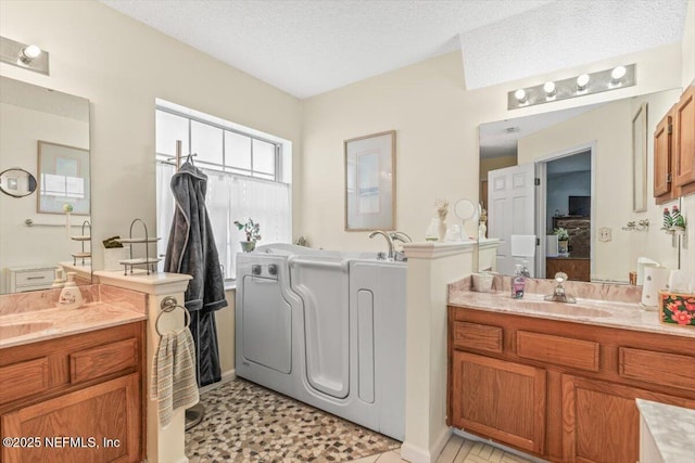 1275 Pirates Cove Ln, Fleming Island, FL 32003 - full bathroom with two vanities, a bath, and a textured ceiling